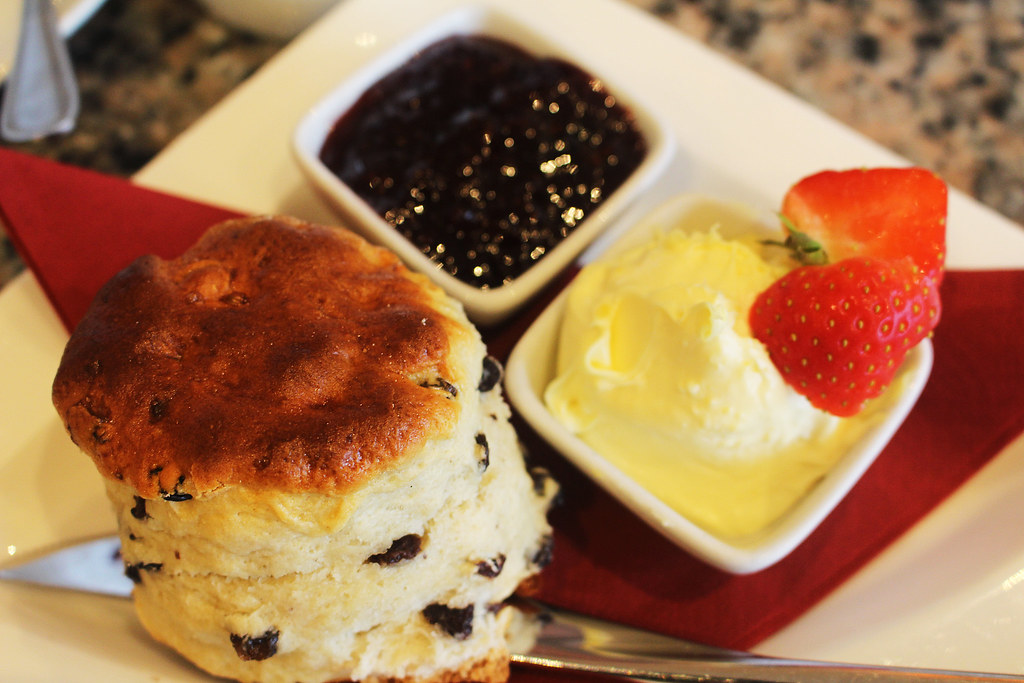 A cream tea: a scone with strawberry jam, clotted cream and fresh strawberries