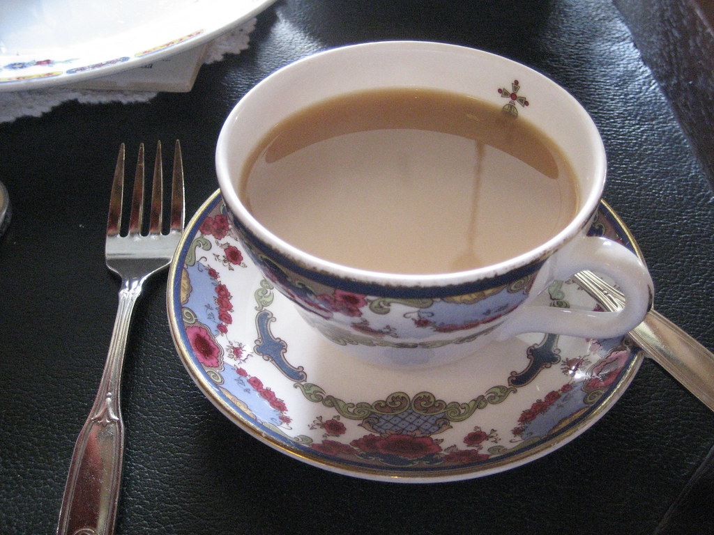 A cup of tea with milk in a floral china cup